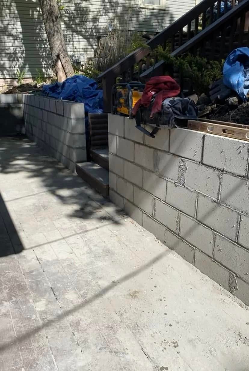 Bare cinder block wall beside outdoor stairs