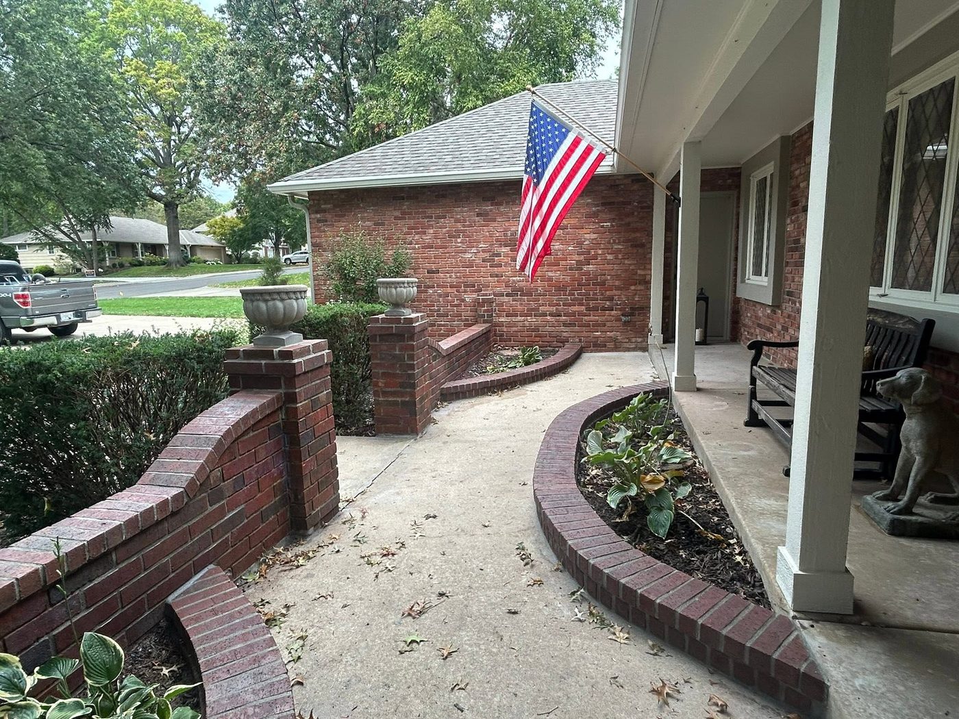 Curved brick planter walls along a front walk