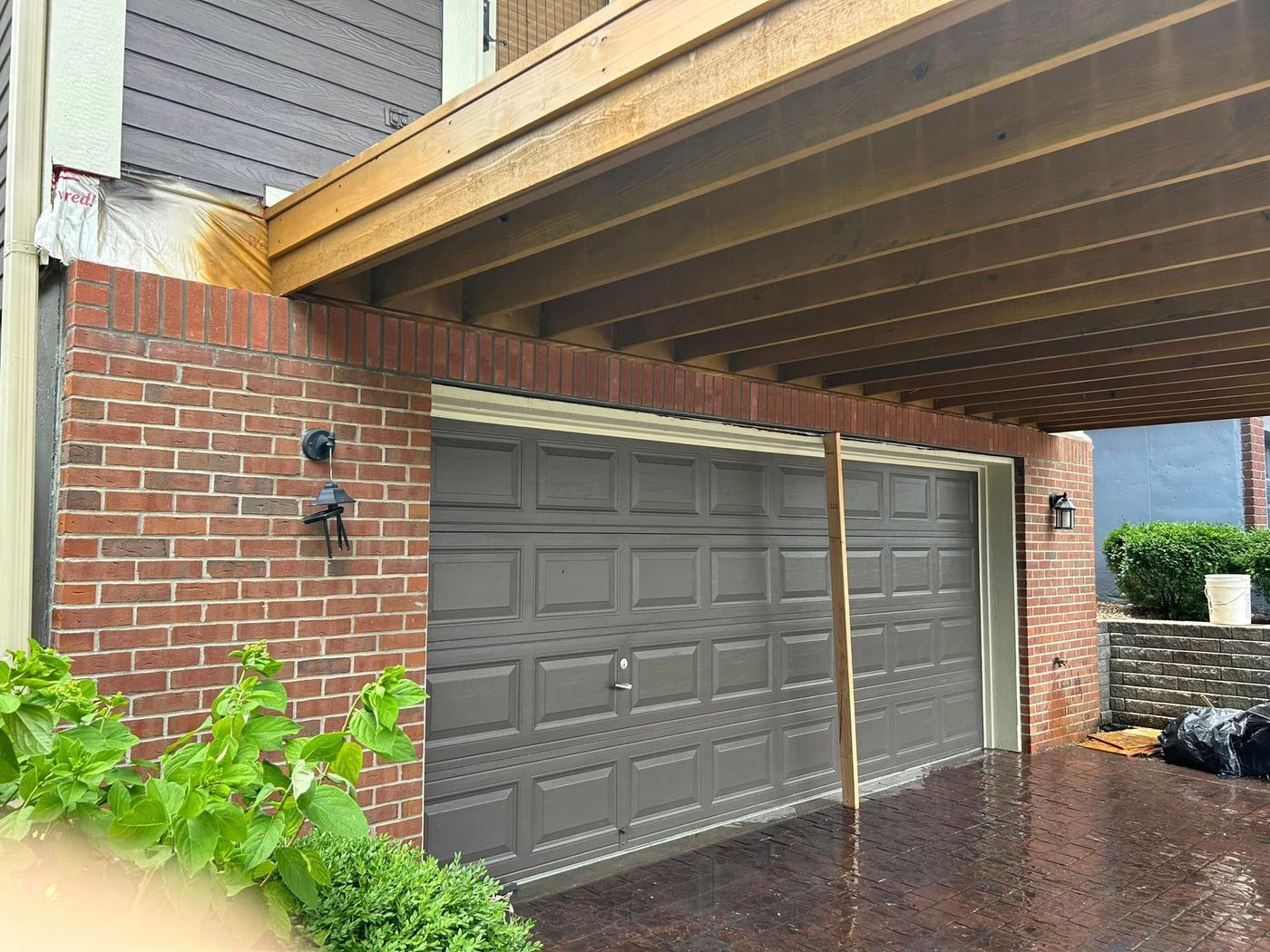 Brick wall around a garage under a deck