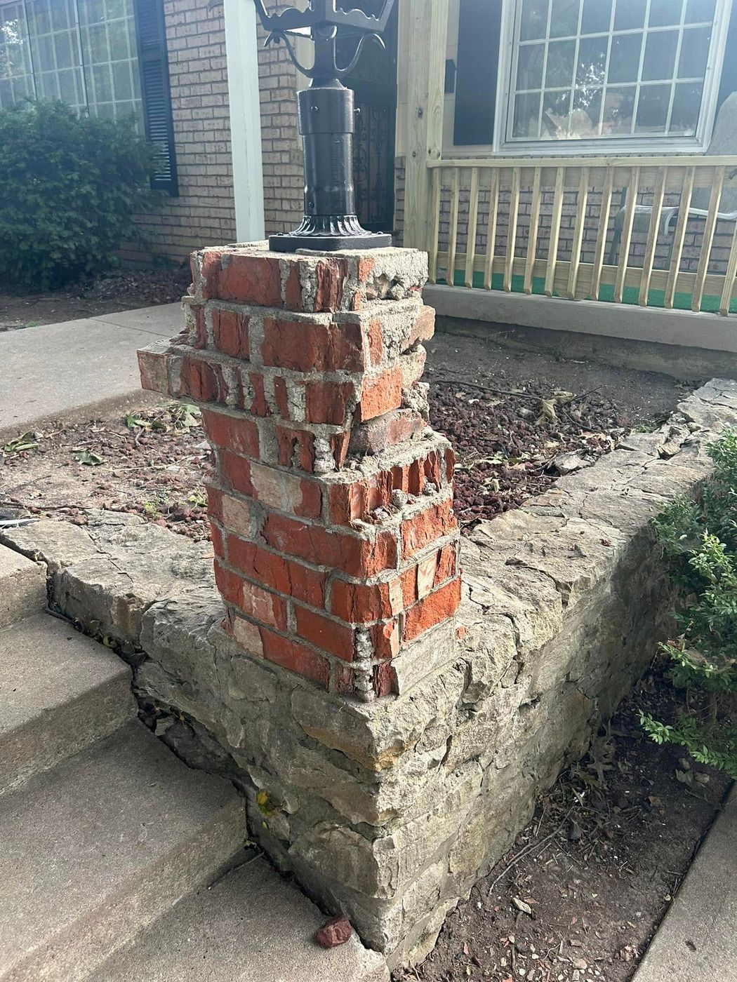 Damaged brick lamp post column