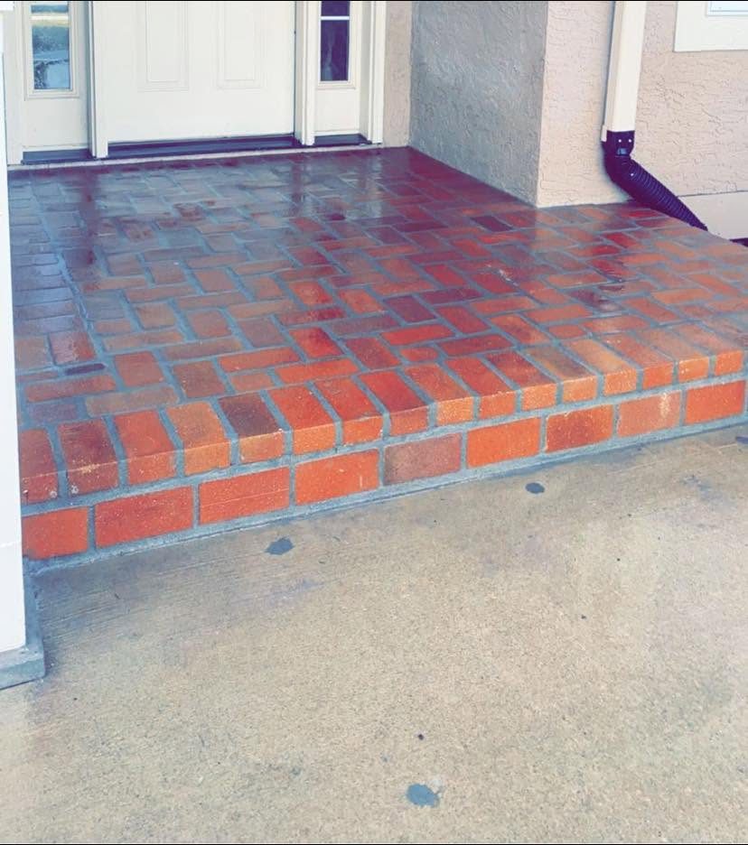 Same entry landing rebuilt in fresh red brick
