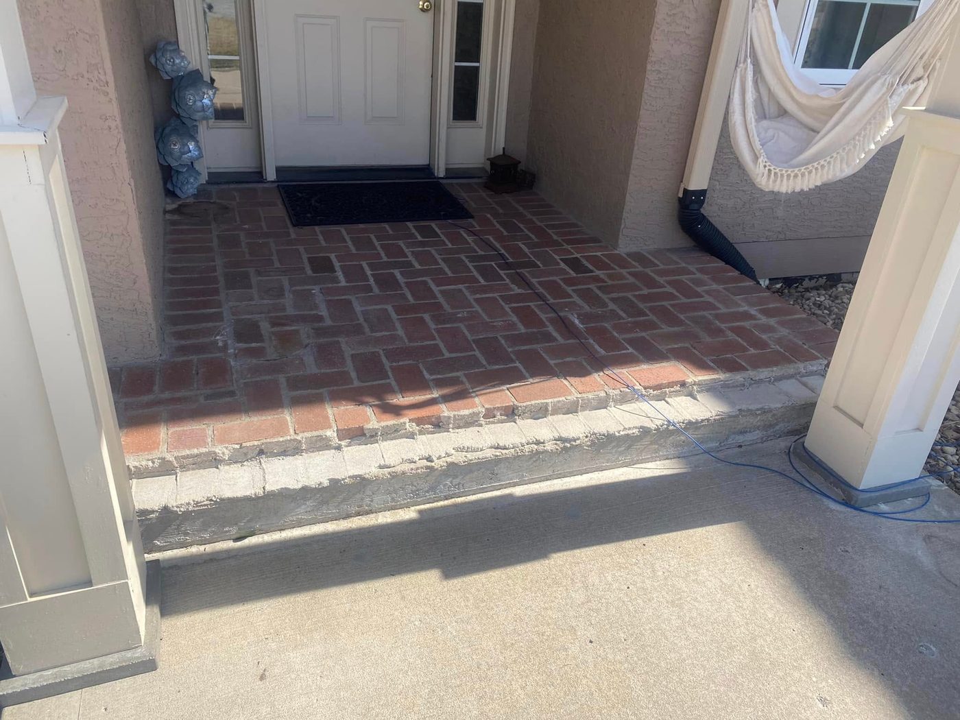 Worn brick entry landing with a crumbling edge