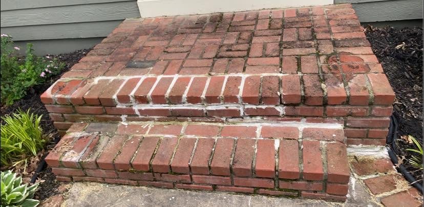 Worn, stained brick steps with failing mortar