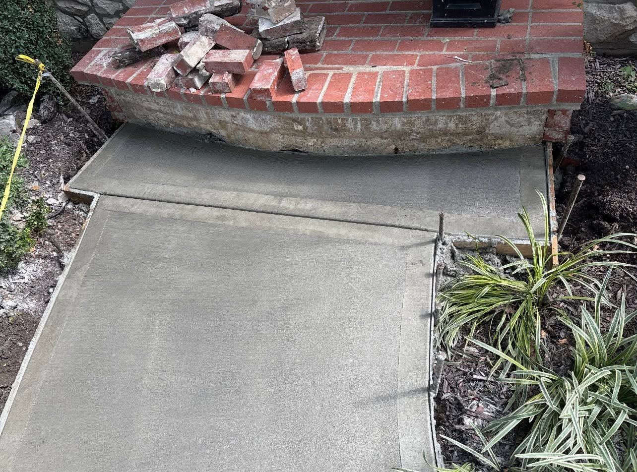 Crumbling brick step torn out for repair