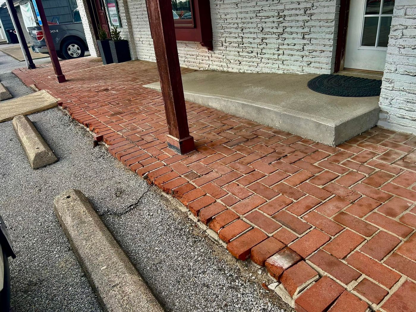 Uneven, sunken herringbone brick sidewalk