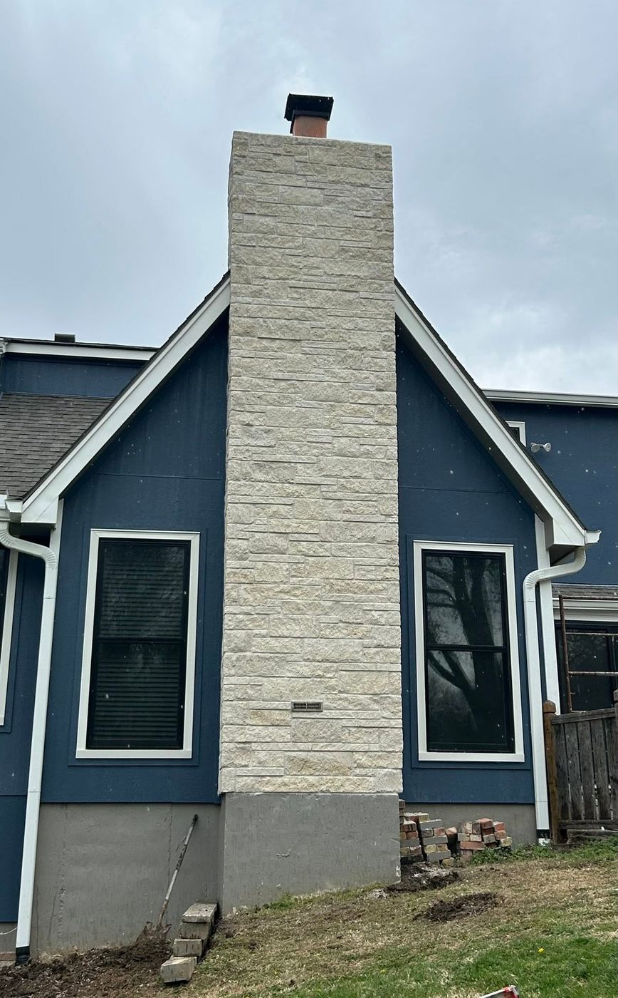 Chimney fully refaced in light stone veneer