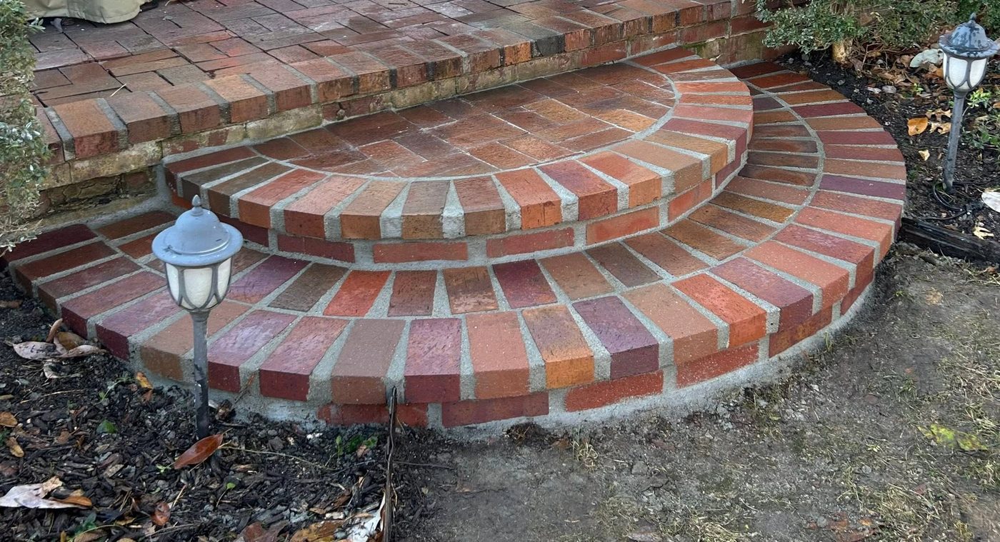 Curved half-round brick steps with lamp posts