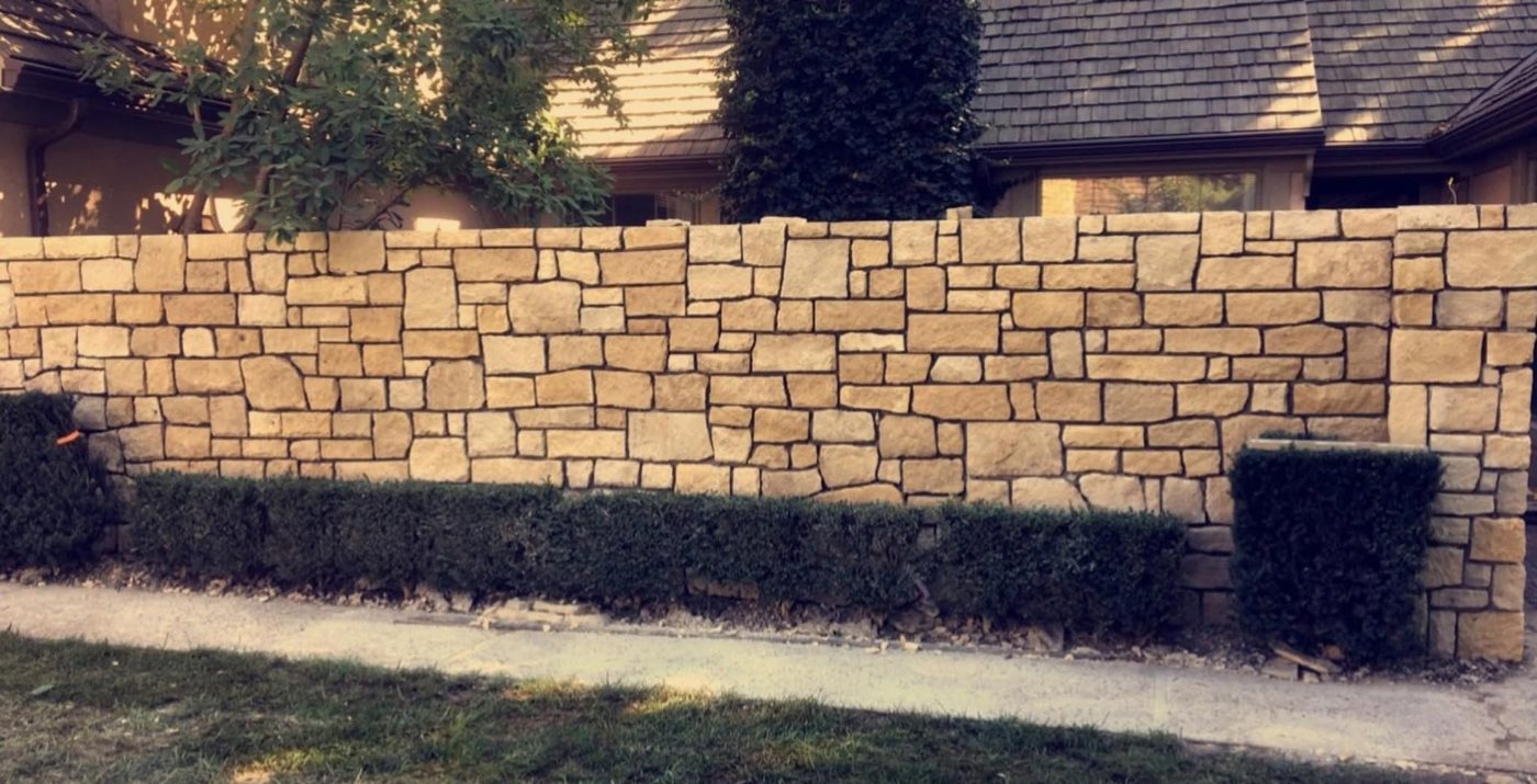 Long cut stone wall in a tight coursed pattern