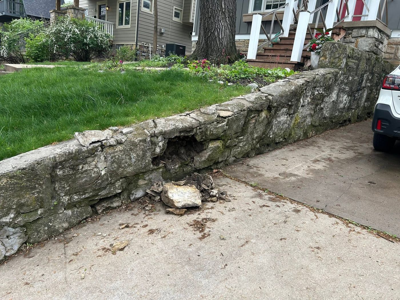 Stone driveway wall with a collapsed section