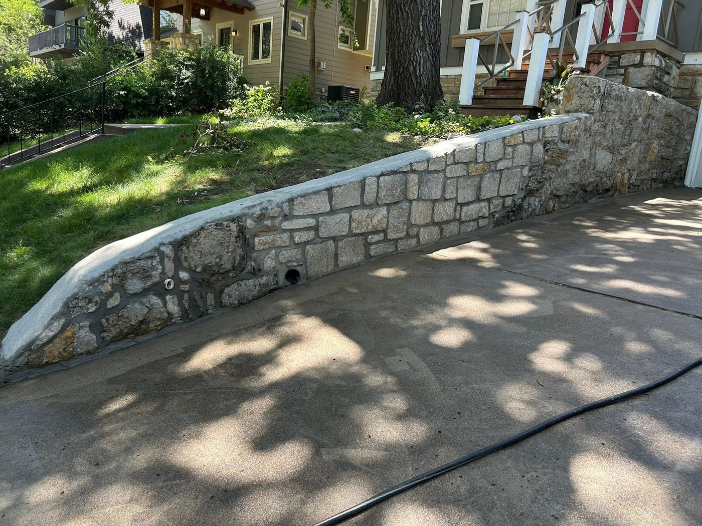 Same driveway wall with the collapsed section rebuilt