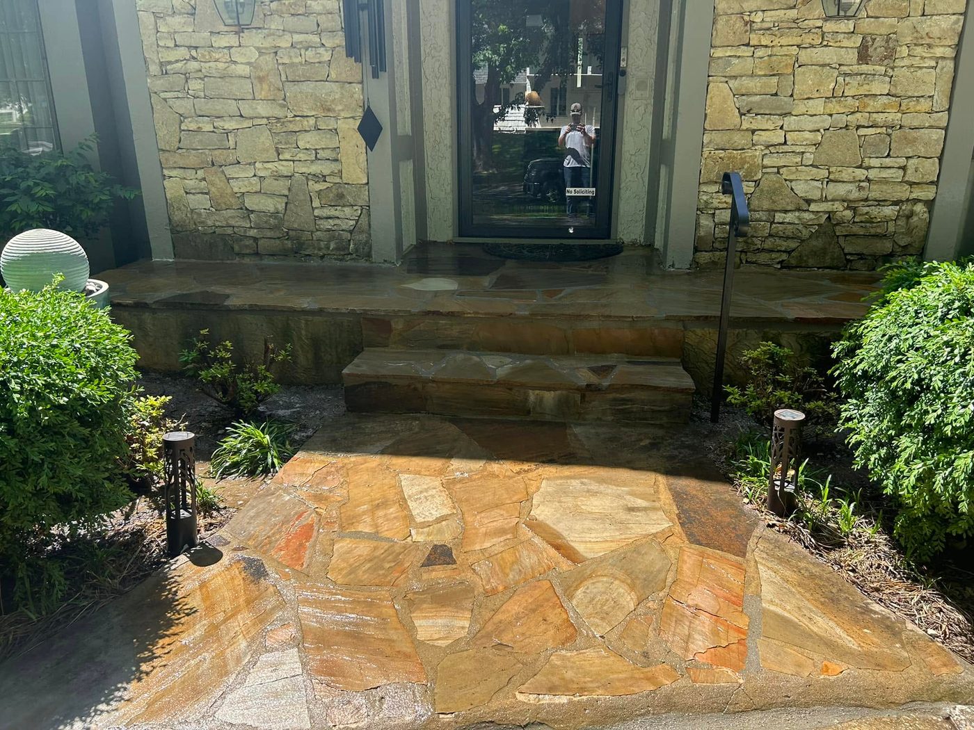 Flagstone entry porch and step at a stone-faced home