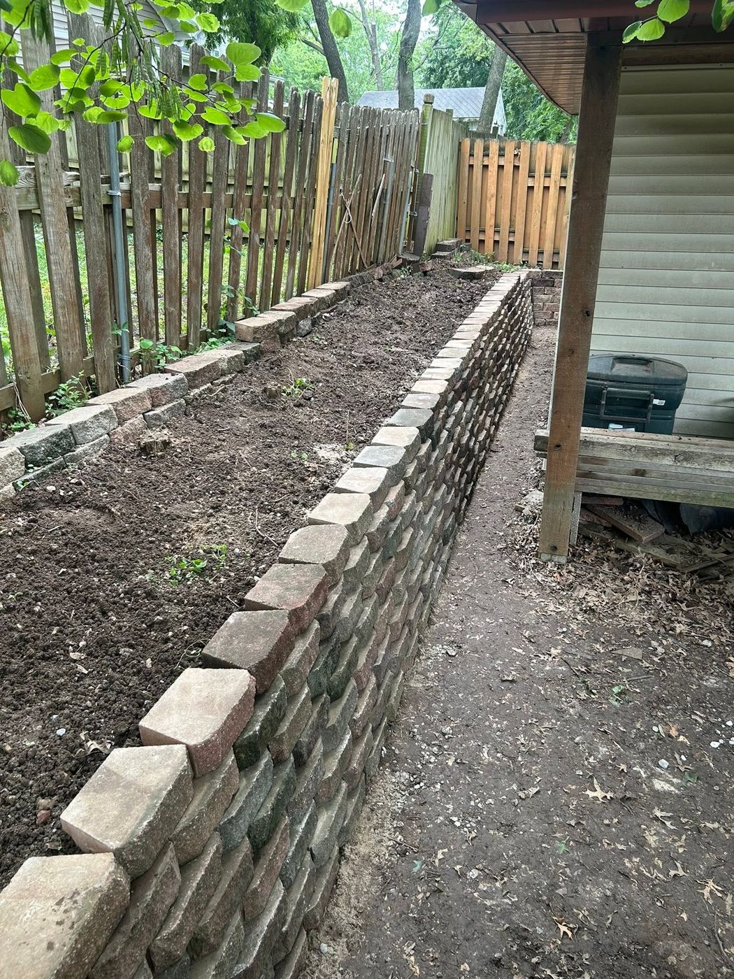 New brick garden wall and raised bed along the fence