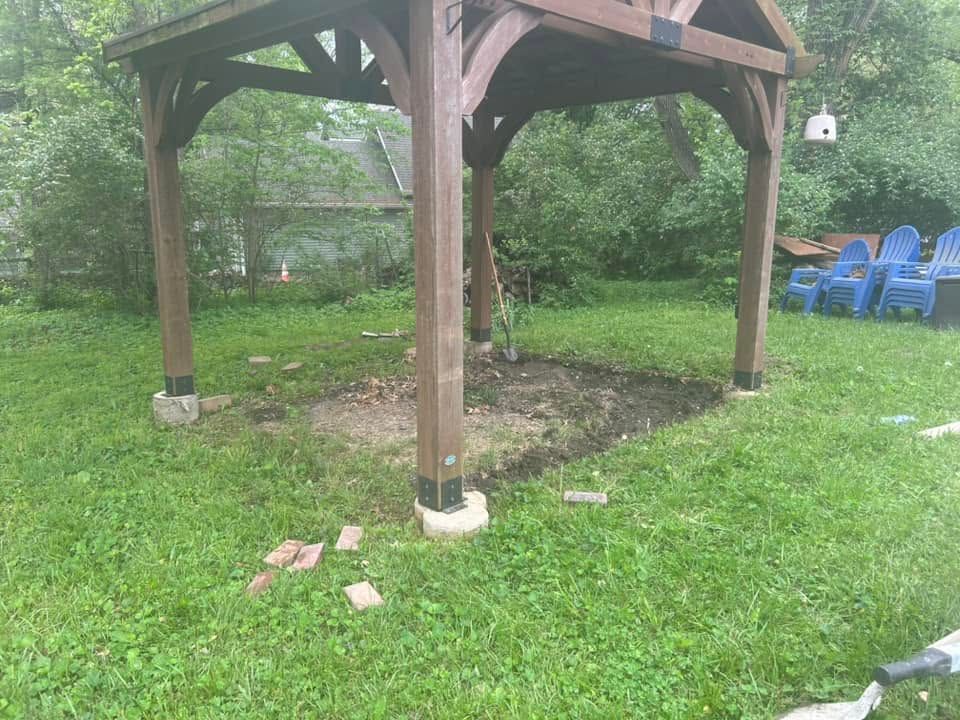 Bare dirt under a wood gazebo
