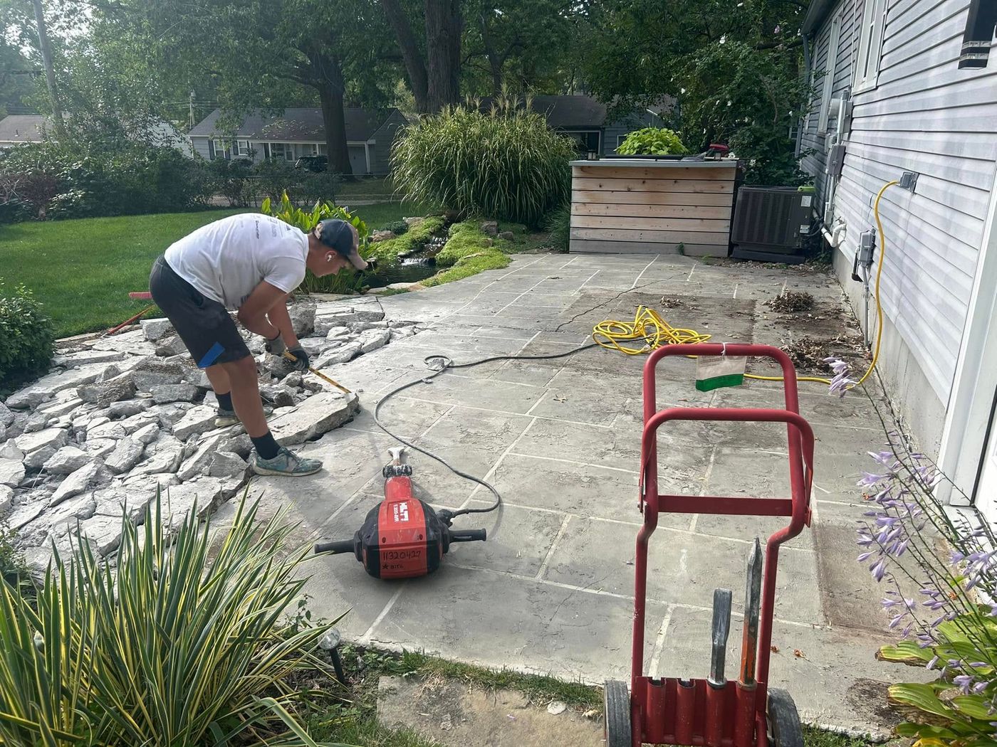 Cracked concrete patio being broken out