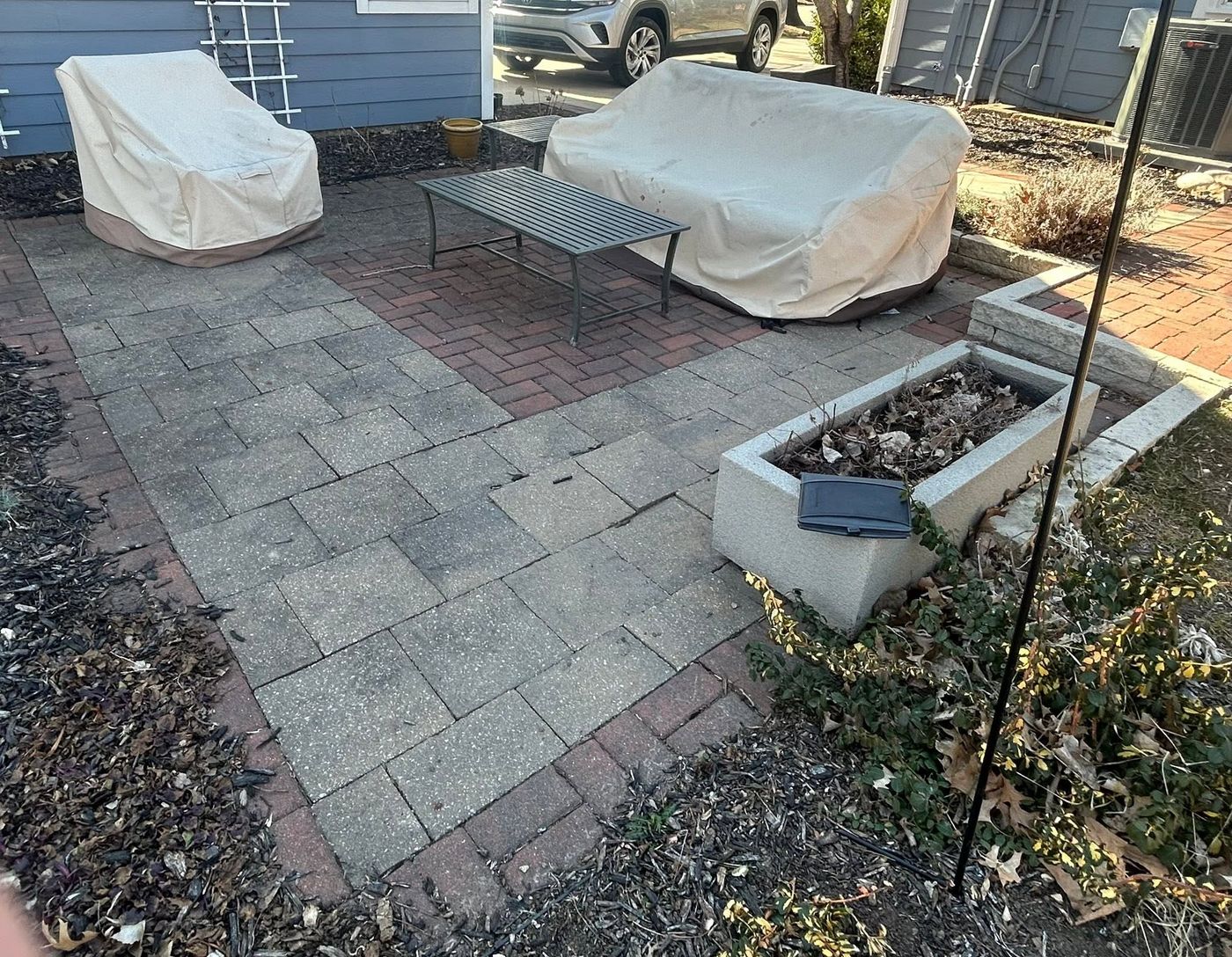 Old, weedy paver patio