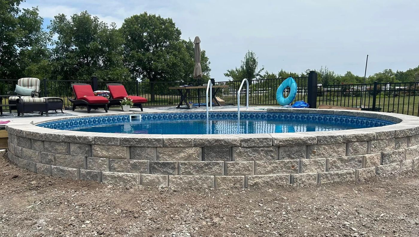 Pool wall refaced in stone block with a cap