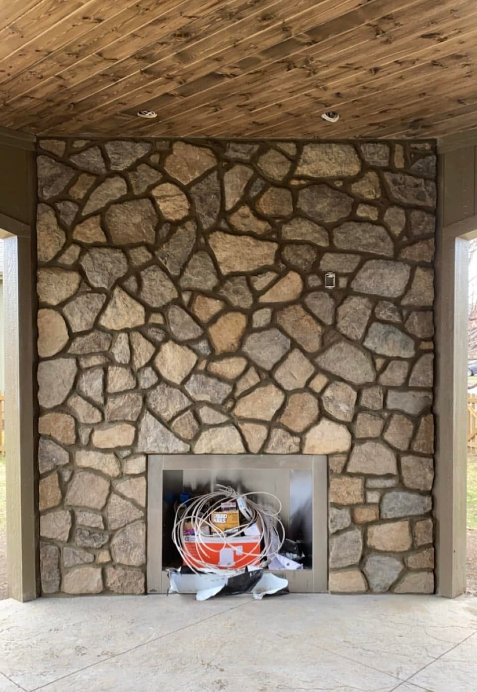 Fieldstone fireplace on a covered porch