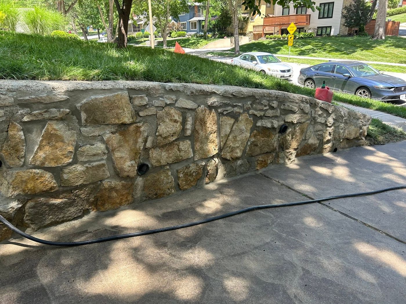 Same driveway wall rebuilt and repointed