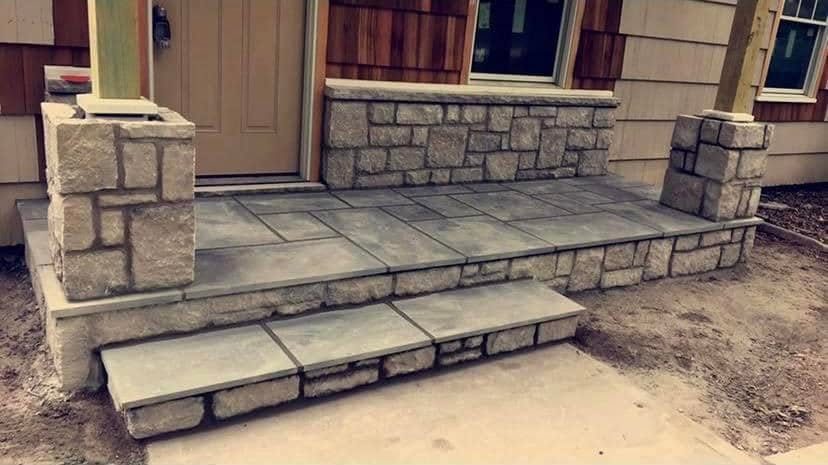 Front porch with stone columns, stone knee wall and flagstone steps