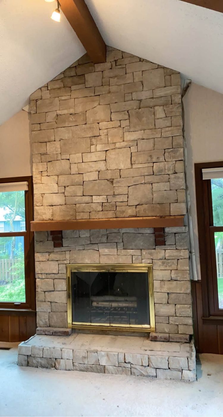 Floor-to-ceiling stacked stone fireplace