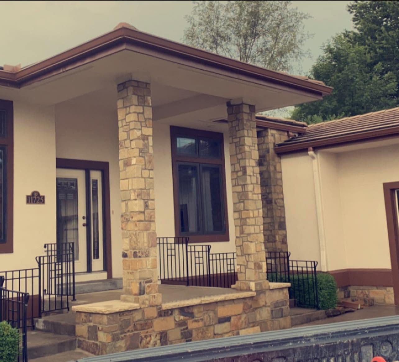 Tan stacked-stone porch columns on a front porch