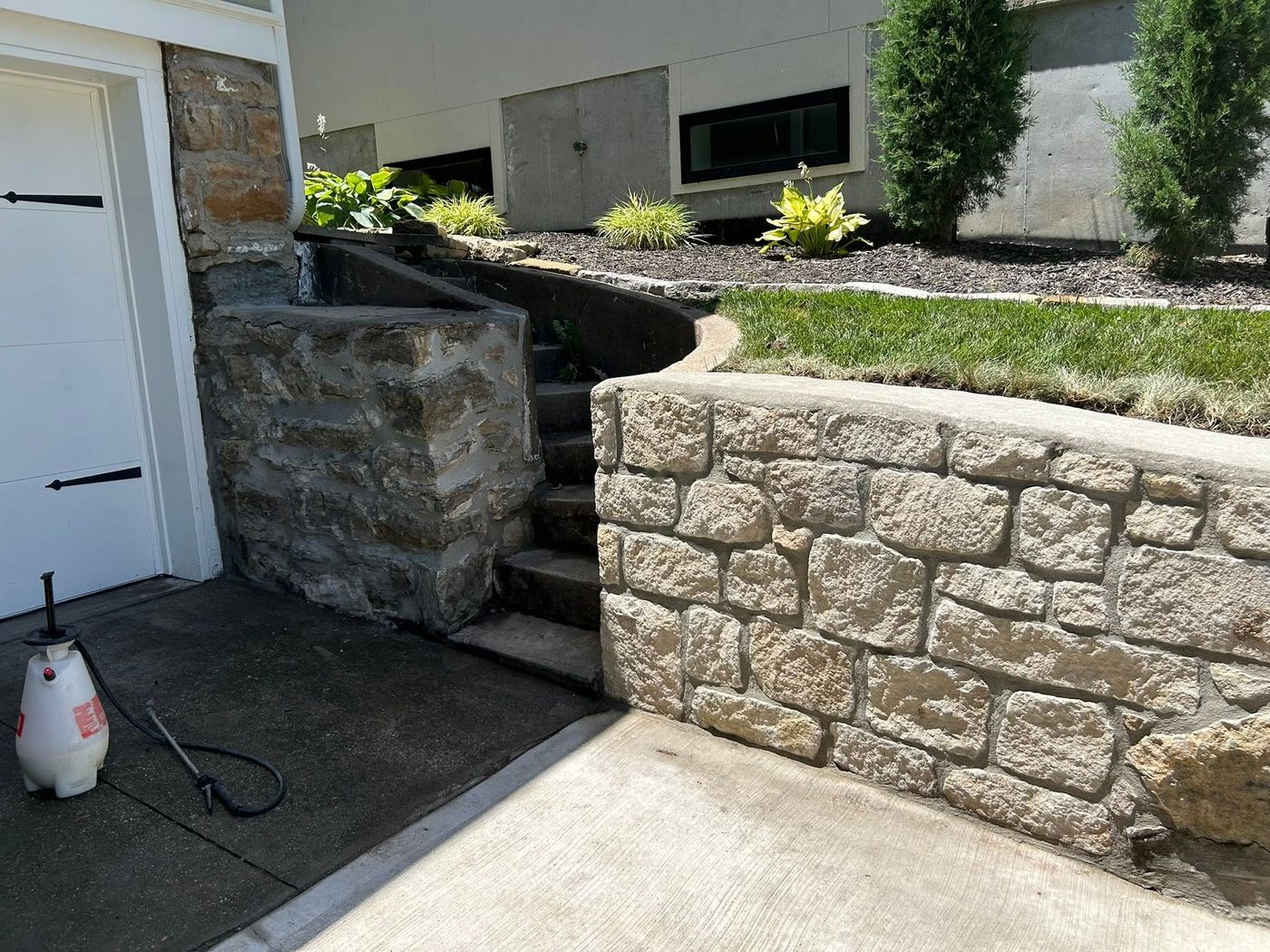 Rebuilt stone stairs and wall beside the garage