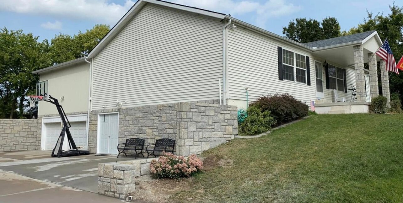Stone veneer foundation and wall by the garage